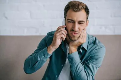 man calling Dr. Sumeet Kaur Family Dentistry scheduling an emergency appointment